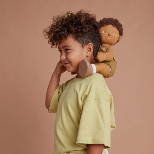 Little boy playing with Button dinkum doll