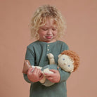 Little boy holding Pea dinkum doll