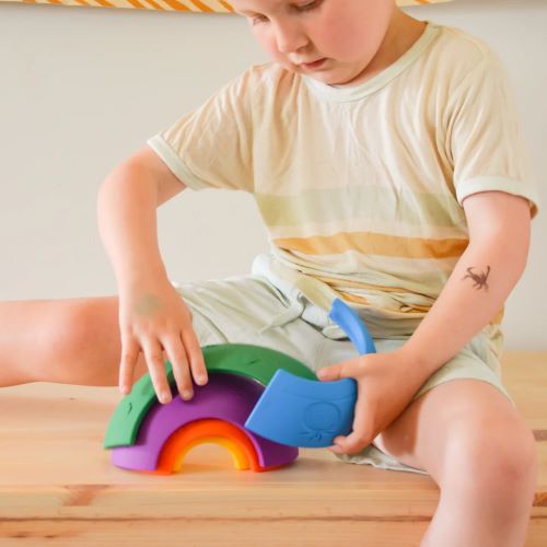 Child playing with over the rainbow stacking toy