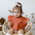 Toddler wearing the palm frill snuggle bib