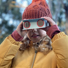 Child using paper binoculars bird spotting