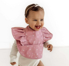 Toddler using the pink fleur frill snuggle bib