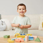 Child playing with the rattle & stack starter blocks