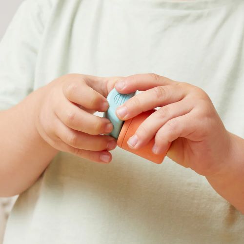 Child playing with the rattle & stack blocks