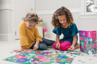 Two girls playing with the secret garden puzzle