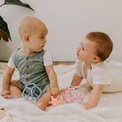 two babies playing with sensory balls