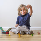 Boy playing with tribe of dinosaurs