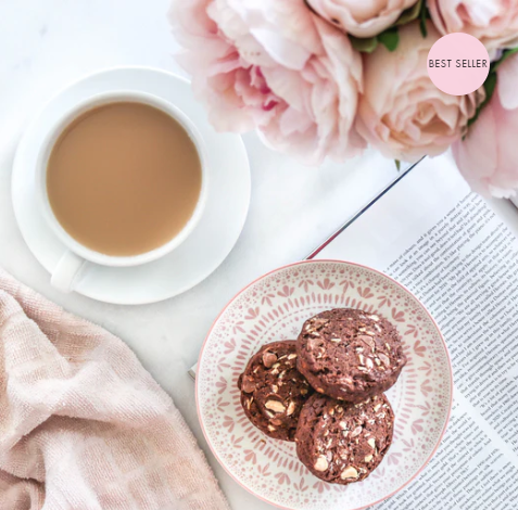 Made to milk triple chocoholic lactation cookies on a plate with a cup of tea.