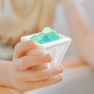 Child holding a Triblox filled with waterballs