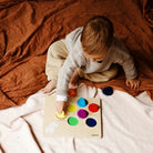 Toddler playing with balloon colour sorter puzzle