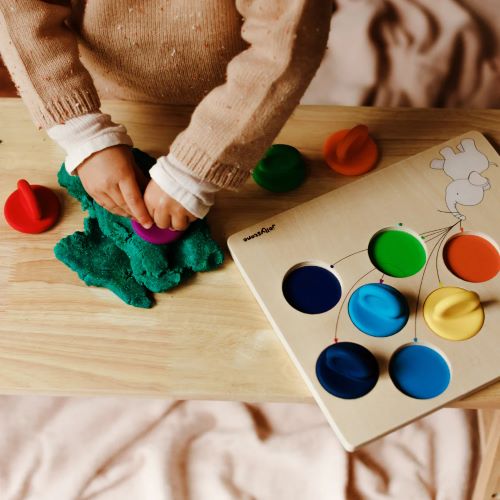 Child using puzzle pieces in playdough of the balloon colour sorter puzzle