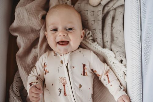 Baby wearing bamboo zipsuit in autumn bear print