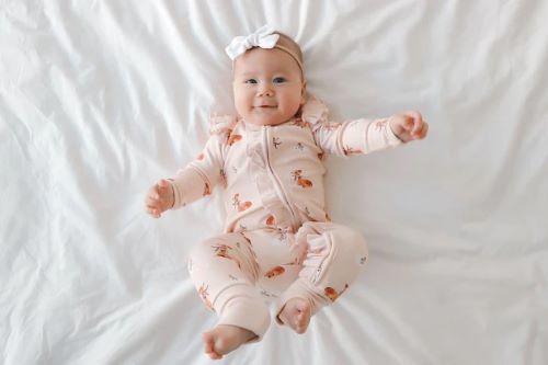 Baby wearing bamboo zipsuit in classic fawn print