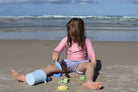 Little girl playing with the beach set on the beach