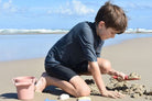 Boy playing with the beach set on the beach