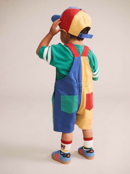the back of a boy wearing colour block pocket shortall