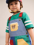 Boy wearing colour block pocket shortall