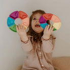 Little girl holding 2 colour wheels