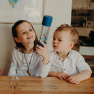 Kids playing with a DIY calm down bottle blue