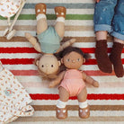 Dinkum dolls on a playmat with a child.