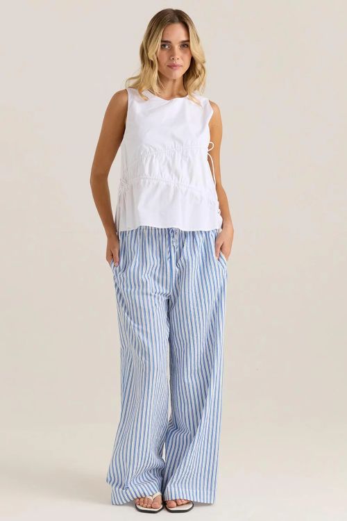 Woman wearing the Elin gathered tie top in white