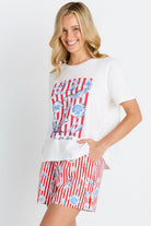 Woman wearing a white t-shirt with a red and blue graphic and a matching skirt on a white background