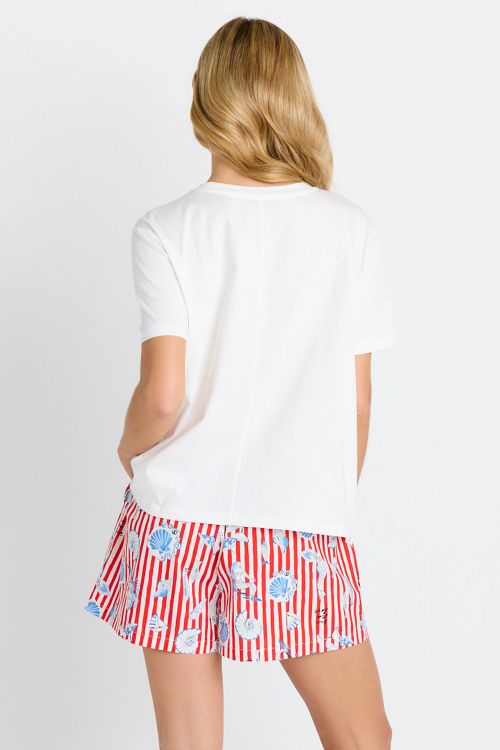 A woman shown from the back wearing a white short-sleeve t-shirt and red-and-white striped shorts with a blue seashell pattern, against a plain white background.