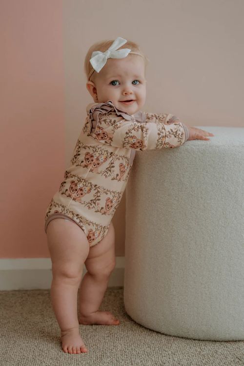 Toddler wearing frilly bodysuit in vintage teddies print