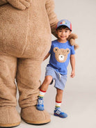 Boy wearing huxbear tee with a bear