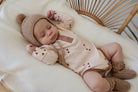 Sleeping baby wearing henley bodysuit in brown hearts print