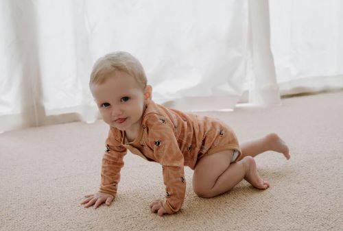 Baby Crawling wearing Henley bodysuit  in bumble bees