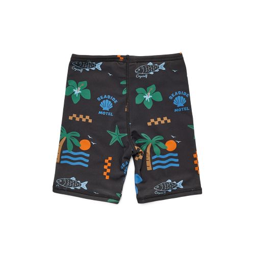 A pair of black swim trunks featuring a colorful tropical pattern with palm trees, fish, waves, and 'Beard's Motel' logos, displayed flat against a white background.