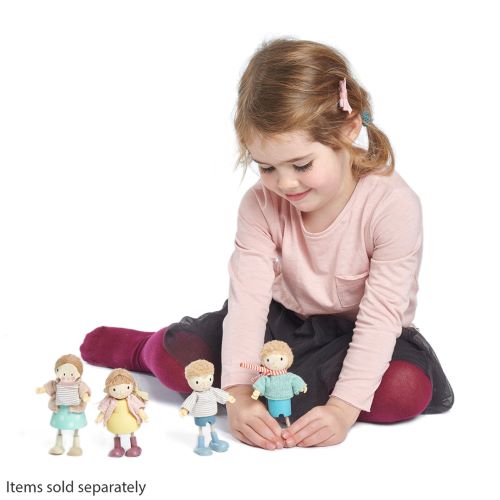 Little girl playing with wooden dolls