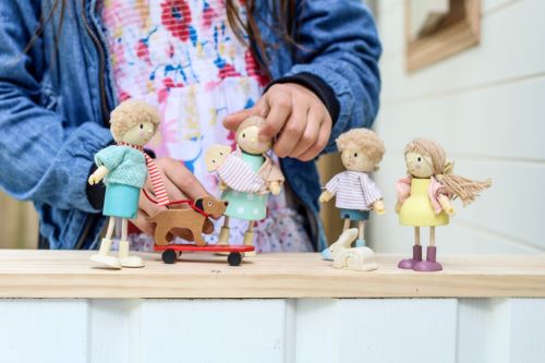 Girl playing with wooden dolls