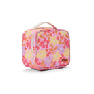 A square-shaped pink lunch bag with a vibrant floral pattern in shades of pink, yellow, orange, and white, featuring a cream-colored top handle and a small brown brand patch on the front.