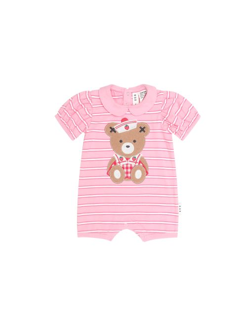 A pink baby short-sleeve romper with thin white horizontal stripes and a teddy bear applique on the chest, shown against a plain white background.