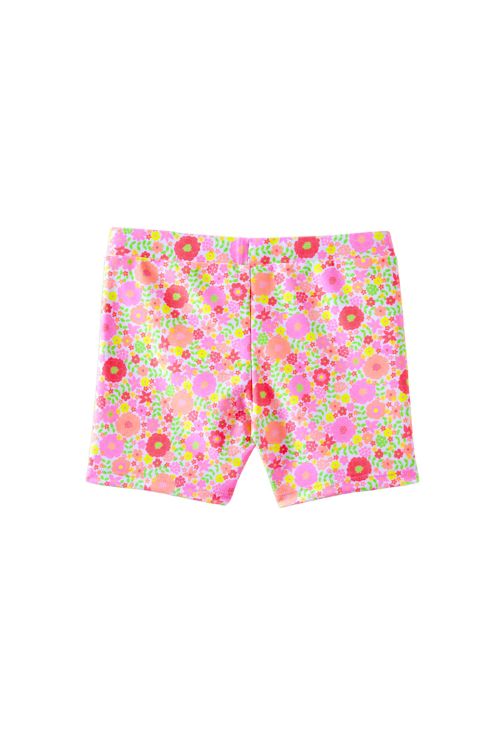 A pair of girls' swim shorts featuring a vibrant, dense floral pattern in pink, orange, green, and red on a light pink base, shown flat against a white background.