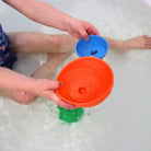 Child in water playing with Ocean stacking cups