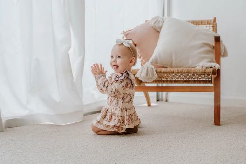 Toddler wearing onesie flutter dress in vintage teddies