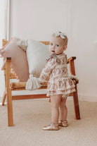 Toddler wearing onesie flutter dress in vintage teddies