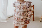 Toddler wearing onesie flutter dress in vintage teddies