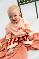 Baby wearing the picnic twill pants in cherry