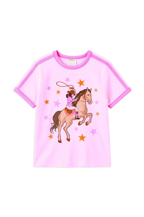A pink short-sleeve kids' t-shirt with contrasting magenta trim on the collar and sleeves, featuring a central graphic of a cowboy riding a brown horse with orange and pink stars.