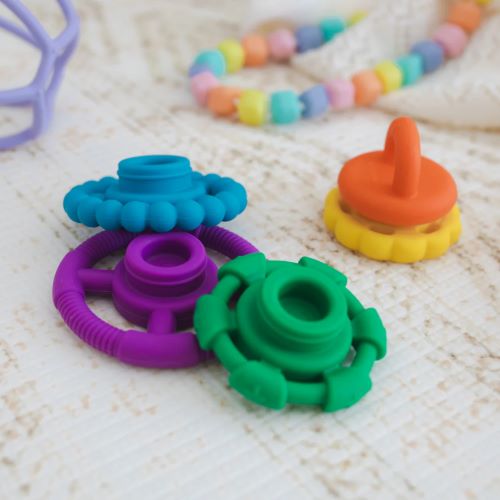 Rainbow stacker and teether and toy on a playmat