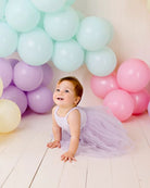 Baby wearing the ribbed tulle dress in lilac