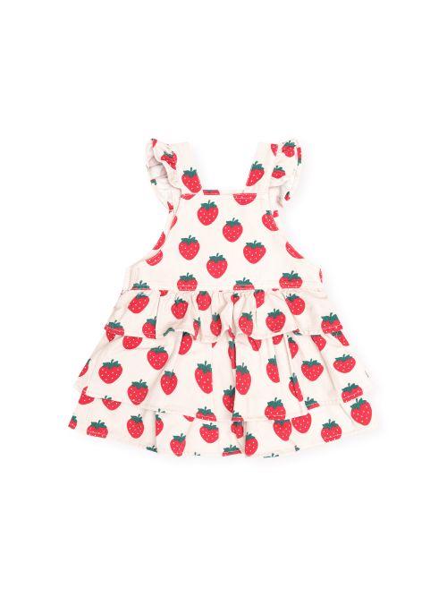 A white tiered baby dress with ruffled shoulder straps, featuring an all-over red strawberry print with green leaves, shown against a plain white background.