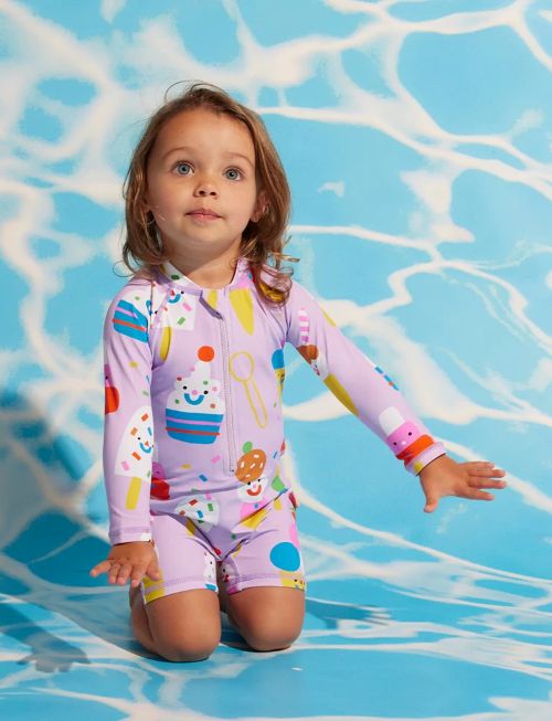 Little Girl wearing the long sleeve rash suit in sundae fun day